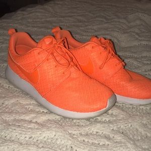 bright orange Nike Roshe runs